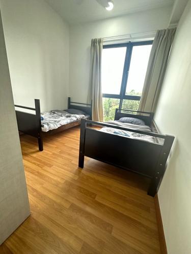 two beds in a room with a window at The Clio 2 Residences, beside zonezion, beside ioi city mall, opposite serdang hospital beside uniteen and UPM, putrajaya in Serdang