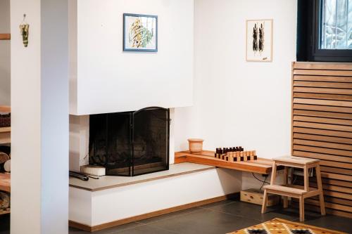 a living room with a fireplace and a table at Modern Flat by Quokka 360 - In the hills bordering Italy in Vacallo