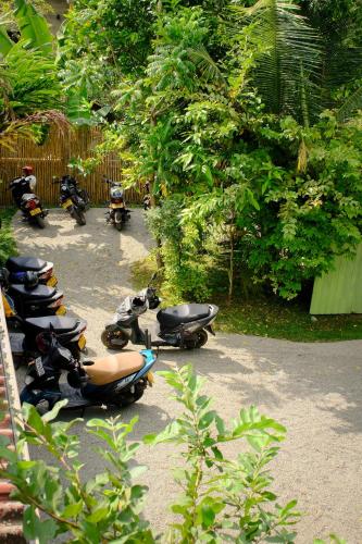 a row of scooters parked in a parking lot at MAKAI Surf House in Ahangama