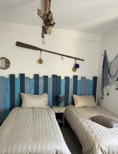 a bedroom with two beds and a stuffed animal hanging from the ceiling at Ô Vieux Moulin in Duras