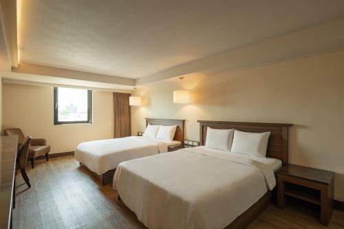 Postel nebo postele na pokoji v ubytování Kindness Hotel - Yuanlin Branch