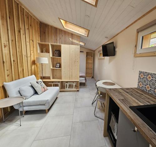 a living room with a couch and a tv at maison avec studio independant dans le centre de soulac - 5306 in Soulac-sur-Mer