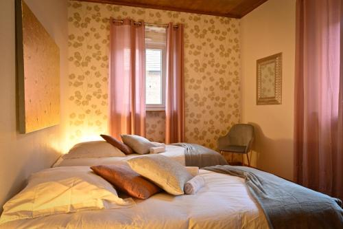 a bedroom with two beds with pillows on it at Le Repos de l'aventurier in Mommenheim