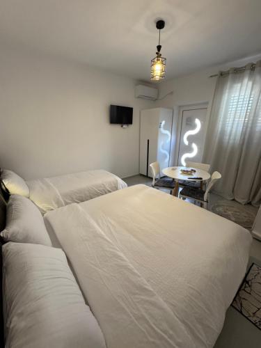 a living room with two beds and a table at Private Villa Aras 2 - Luxury & Elegance Apartments in Vlorë