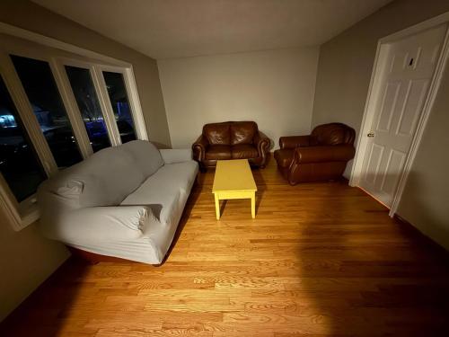 a living room with a couch and a table at UPTOWN WATERLOO-KWC ROOM-Best Location,Lowest Prices in Waterloo