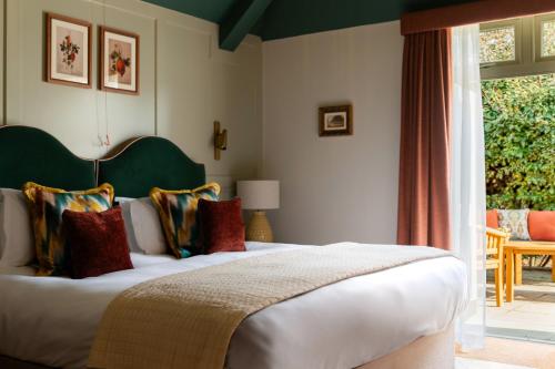 a bedroom with a large bed and a window at Coach & Horses Hotel in London