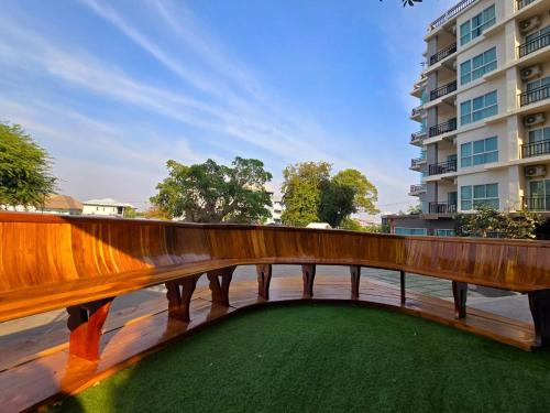 a wooden bridge over a body of water with a building at LHC HOTEL AND RESORT in Pattaya Central
