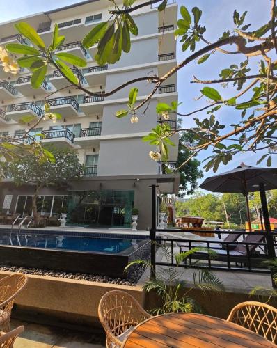 a hotel with a swimming pool and a building at LHC HOTEL AND RESORT in Pattaya Central