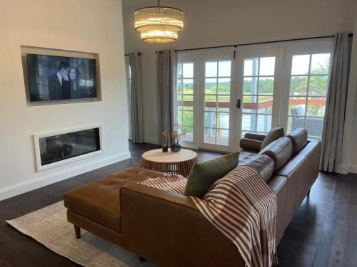 a living room with a couch and a fireplace at Pokolbin Farm Stay in Pokolbin