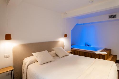 a bedroom with a large bed with a blue light at Agave in Centrale in Milan