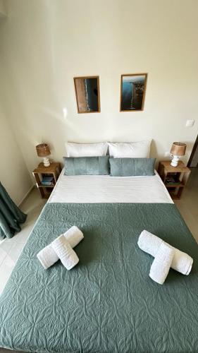 a bedroom with a bed with two towels on it at Golden sand apartment A in Hersonissos