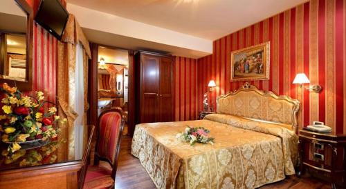 a hotel room with a bed with flowers on it at Zulian B in Venice