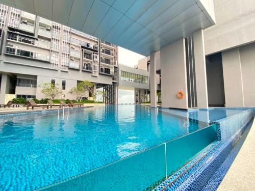 a large swimming pool in the middle of a building at Imperio Residence Melaka in Melaka
