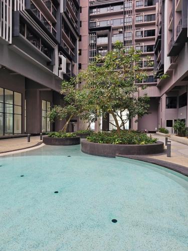 an empty courtyard with a tree in a building at Imperio Residence Melaka in Melaka