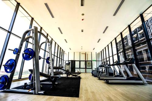 a gym with treadmills and elliptical machines at Imperio Residence Melaka in Melaka
