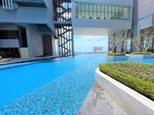 a swimming pool in the middle of a building at Imperio Residence Melaka in Melaka