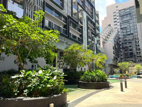 a courtyard in a building with trees and buildings at Imperio Residence Melaka in Melaka