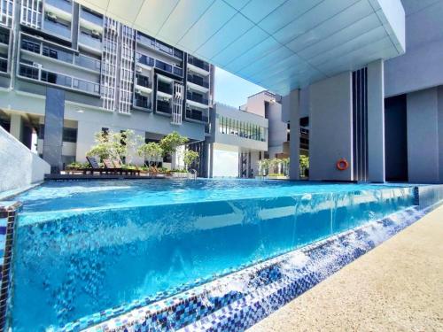 a swimming pool in front of a building at Imperio Residence Melaka in Melaka