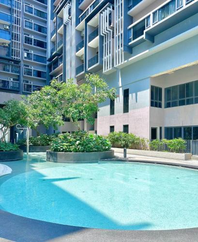 a large swimming pool in front of a building at Imperio Residence Melaka in Melaka