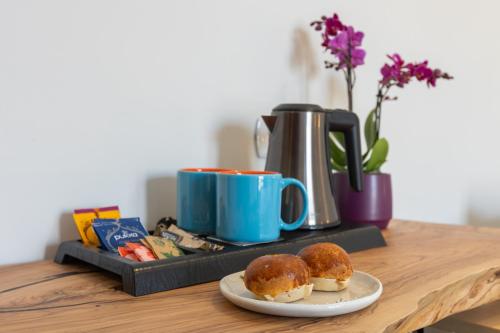 a table with two donuts and a cup of coffee at Centro storico via Sassari Accommodation in Cagliari