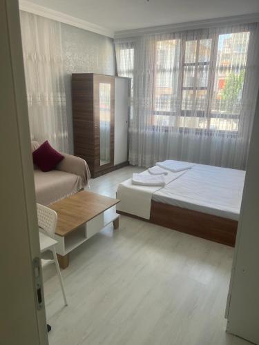 a bedroom with a large bed and a couch at Antalyanın kalbinde teraslı odalar in Antalya