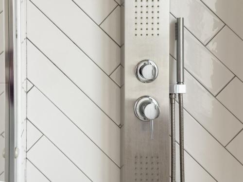 a shower with a shower head in a bathroom at Centro storico via Sassari Accommodation in Cagliari