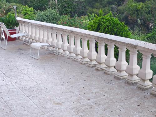 a white railing on a patio with two chairs at Chalet at Villa Don Quijote Nice in Nice