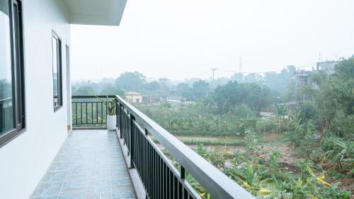 a balcony of a house with a view at Tam Coc Gold Smile Homestay in Vũ Lâm
