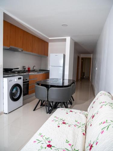 a kitchen with a table and a kitchen with a stove at Appartement moderne avec vue sur la mer in Praia
