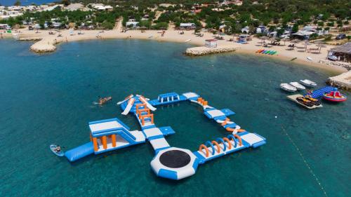an aerial view of an island in the water at Villa Domenica - Luxury Apartment with Pool, Hot Tub & Sea View in Novalja