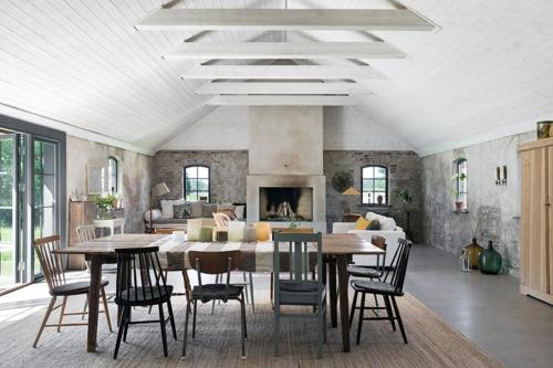 a living room with a table and chairs and a couch at Unique house outside Borås in Fritsla