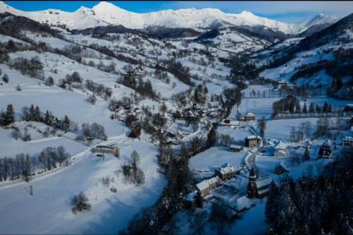 an aerial view of a village in the snow at Maison au pied du puy mary in Saint-Julien-de-Jordanne
