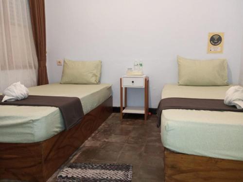 Postel nebo postele na pokoji v ubytování Ijen & Sleep Homestay