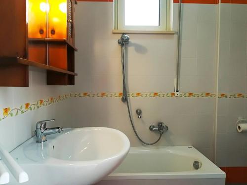 a bathroom with a sink and a shower and a tub at Casa Elettra in Otranto in Otranto
