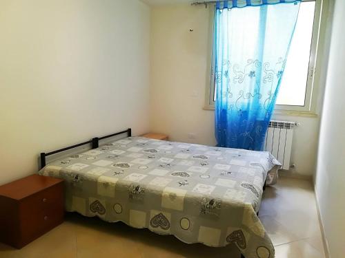 a small bedroom with a bed and a window at Casa Elettra in Otranto in Otranto