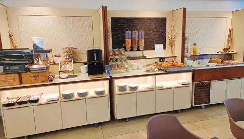 a kitchen with a buffet of food on display at Hotel President in Prato