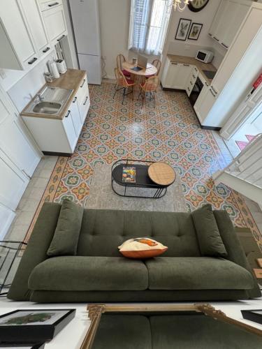 a living room with a green couch and a table at Stylish Boutique Duplex Apartment Home - Green - 2 Large Double Bedrooms with Ensuite Bathrooms in Msida