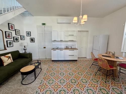 a living room with a couch and a table at Stylish Boutique Duplex Apartment Home - Green - 2 Large Double Bedrooms with Ensuite Bathrooms in Msida