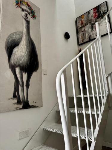 a painting of a peacock on a wall next to a staircase at Stylish Boutique Duplex Apartment Home - Green - 2 Large Double Bedrooms with Ensuite Bathrooms in Msida