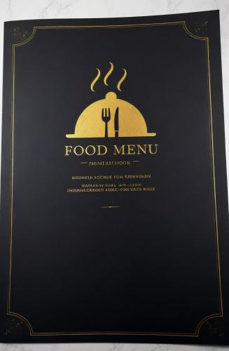 a black menu board with a fork and a food menu at Beachfront Luxury Villa Glory in Ayia Napa