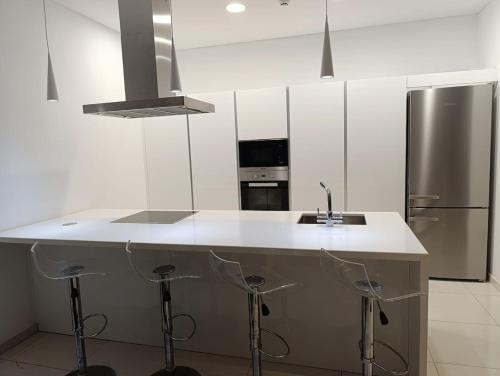a kitchen with a sink and a refrigerator at Beachfront Luxury Villa Glory in Ayia Napa
