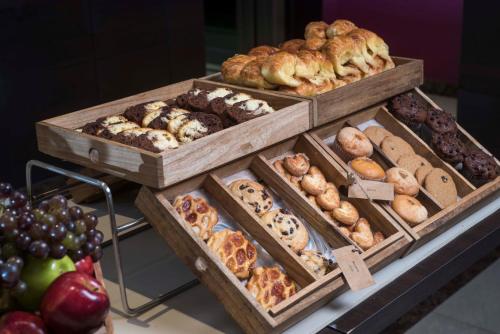 a display of different types of pastries in wooden boxes at ARC Recoleta Boutique Hotel & Spa in Buenos Aires