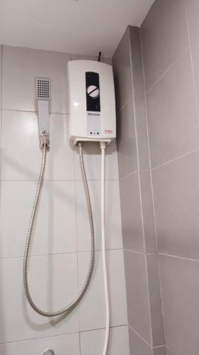 a shower in a bathroom with a phone on the wall at Elio Del Ray Studio walk to BTS in Bangkok