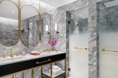 a bathroom with two sinks and a shower at Grand Lisboa Palace Macau in Macau