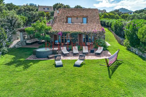 an aerial view of a house with chairs and a backyard at Domus de pedra in Marina di Portisco