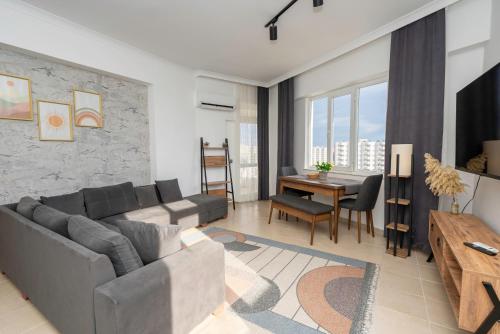 a living room with a couch and a table at B lackstone Homes in Aksu