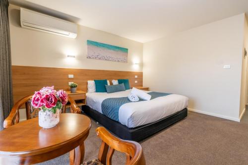 Ένα ή περισσότερα κρεβάτια σε δωμάτιο στο Rainbow Motel Queanbeyan
