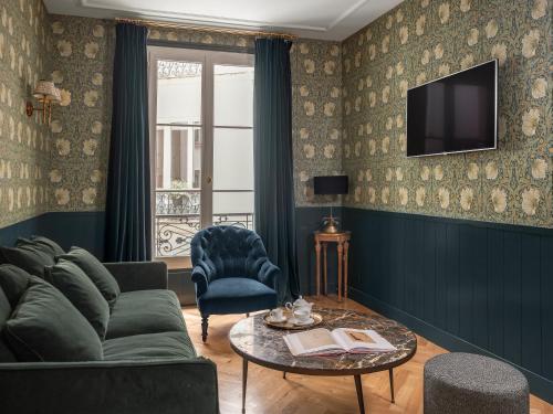 a living room with a couch and a table at Maison Malesherbes in Paris