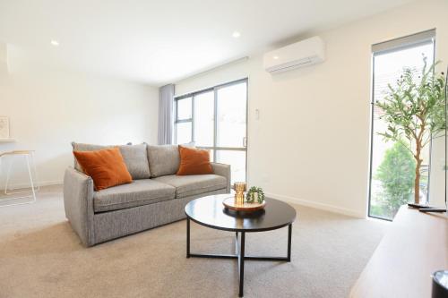 a living room with a couch and a table at Modern 2-Bed Townhouse Close to City Attractions in Addington