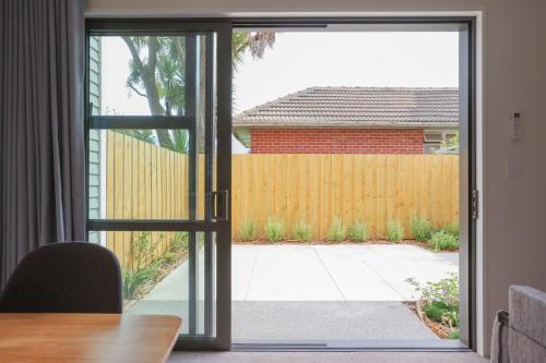 an open door to a yard with a fence at Modern 2-Bed Townhouse Close to City Attractions in Addington